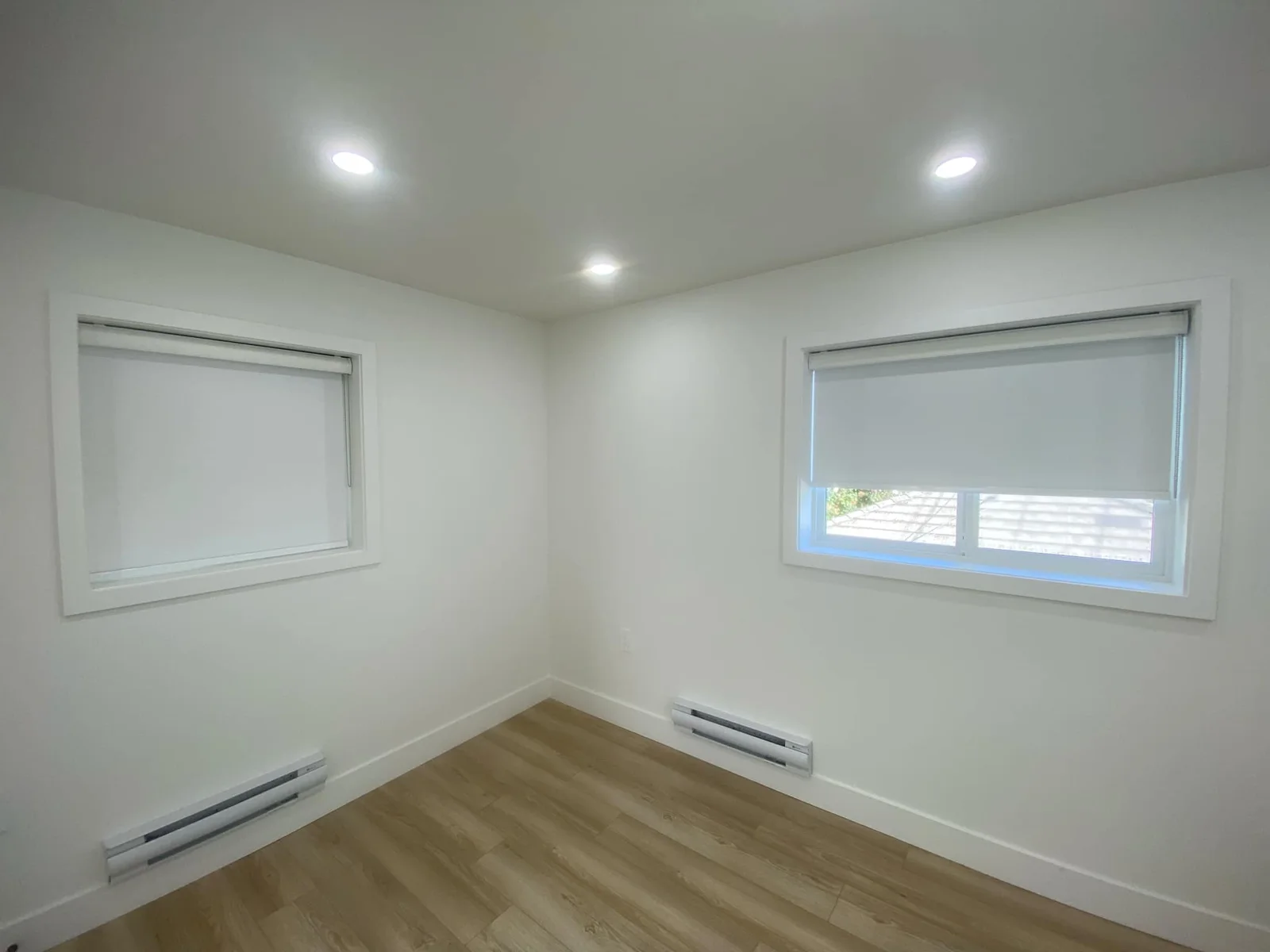 White roller shades on corner windows